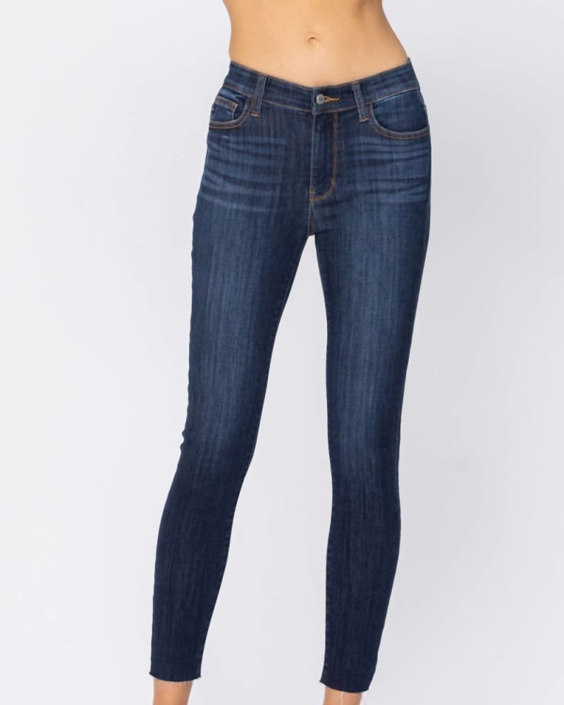 Front of a model wearing a size 24W Mid- Rise Raw Hem Skinny Jean in Blue in Blue by Judy Blue. | dia_product_style_image_id:326093